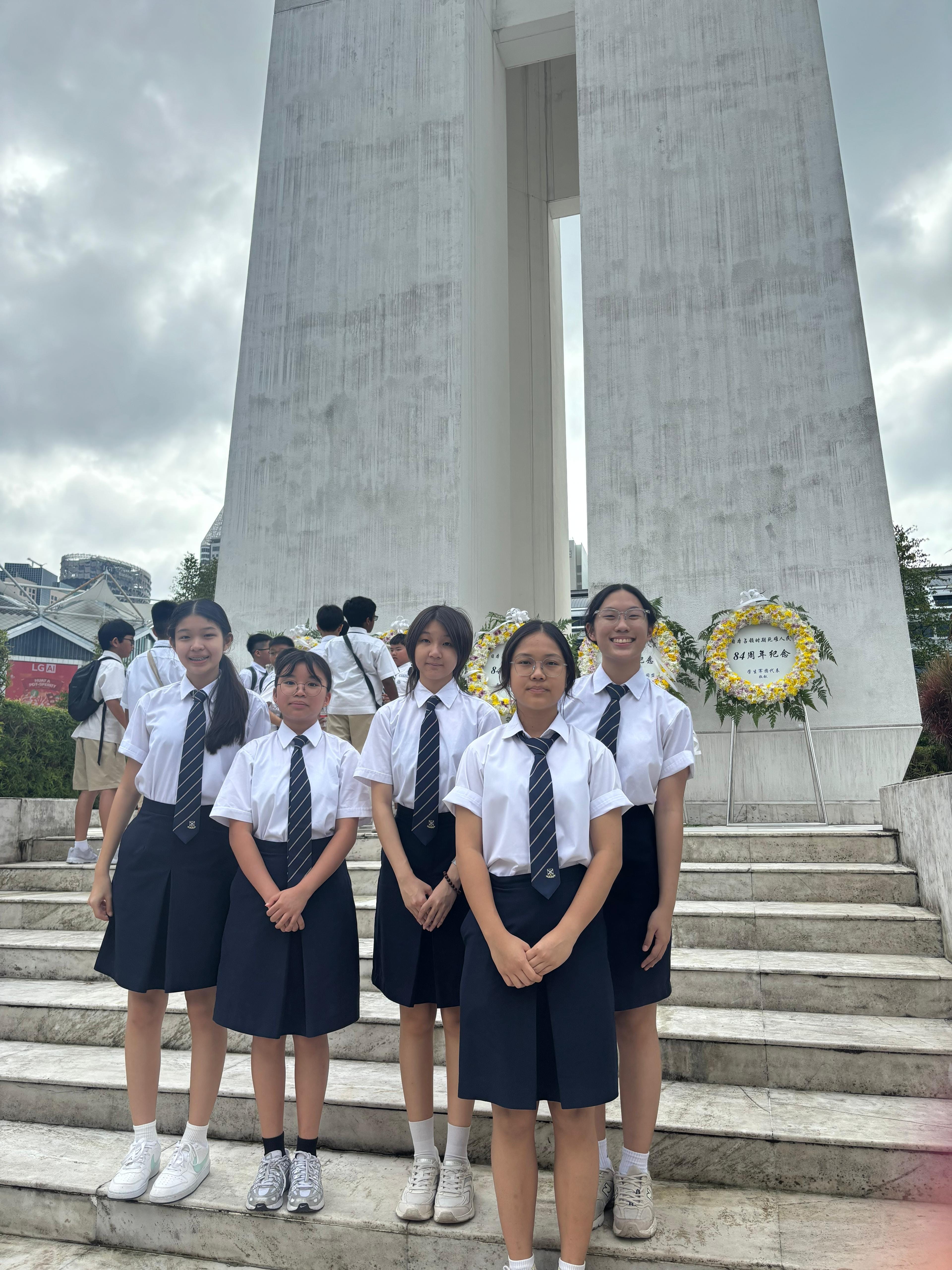 Students posing in front of the War Memorial at the War Memorial Park.